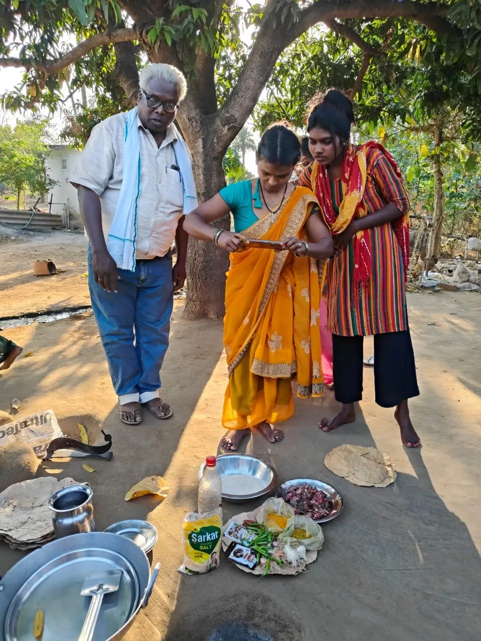 Karya workers gathered outdoors during a field session