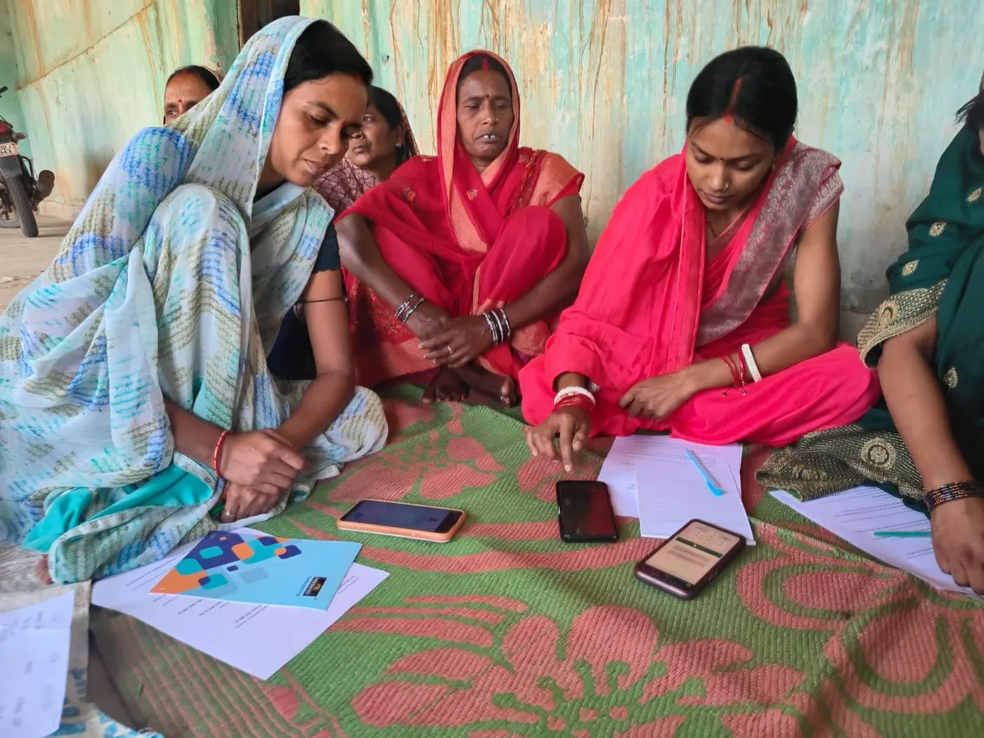 Karya workers working through tasks around a shared mat